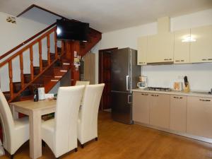 a kitchen with a table and chairs and a refrigerator at Sibiu Home 4 Green in Sibiu