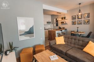 a living room with a couch and a table at Sunrise Luxury Apartment in Bitola +41 photos