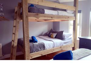 a bedroom with two bunk beds in a room at California Lodge in Portstewart