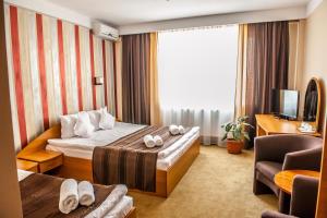 Hotel Class Hermannstadt في سيبيو: غرفه فندقيه سرير وتلفزيون