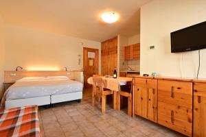 Posteľ alebo postele v izbe v ubytovaní Residence Raethia tra Bormio e Livigno