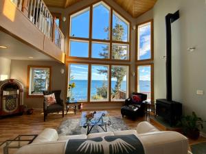 a large living room with large windows and the ocean at Goldilocks Bed & Breakfast in Kodiak