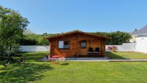 a small cabin with a table and chairs in a yard at Wild Atlantic Way Cabin in Ballyheigue +36 photos