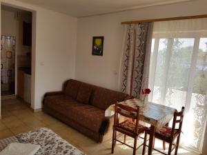 a living room with a couch and a table at Guesthouse Domenik in Ulcinj