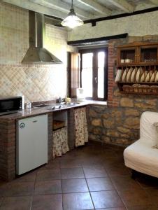 a kitchen with a sink and a counter top at Apartamentos La Huertona in Queveda