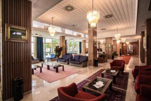 a lobby of a hotel with couches and chairs at Hotel San Pietro in Cesenatico