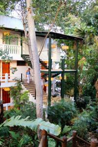 a person walking down the stairs of a house at Hotel Maya Internacional in Flores