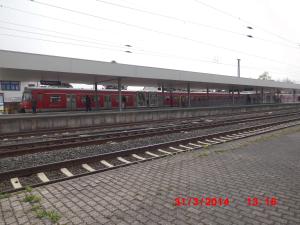 a red train is parked at a train station at Frankfurt Airport & Fair Apartment in Kelsterbach