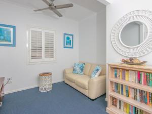 a living room with a couch and a mirror at Avalon 1 in Yamba
