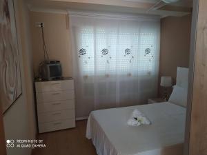 Posteľ alebo postele v izbe v ubytovaní Apartamento Manuel