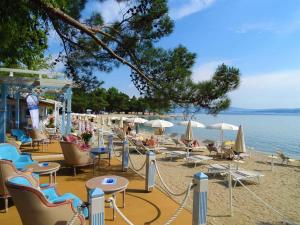 a beach with chairs and tables and umbrellas at Holiday home in Dramalj 5745 in Dramalj