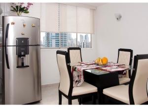 ein Esszimmer mit Tisch und Kühlschrank in der Unterkunft III NICE 2 BEDROOM APARTMENT Bocagrande in Cartagena de Indias