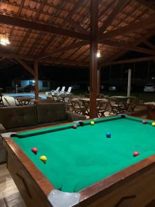 a pool table with balls on top of it at Pousada Guimaraes in São Pedro da Serra