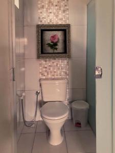 a bathroom with a toilet and a picture on the wall at Hotel Amazonia in Castanhal