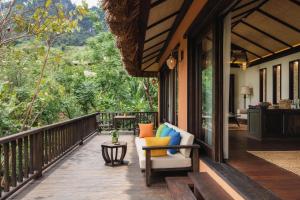 a porch with chairs and a view of the forest at Avana Retreat in Mai Chau