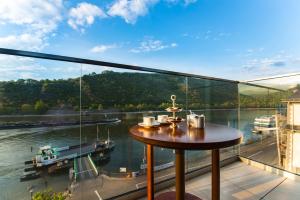 einen Balkon mit einem Tisch und Flussblick in der Unterkunft Residence Bellevue in Boppard