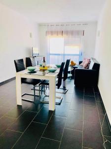 a dining room with a white table and chairs at Albufeira Beach side Apartment in Albufeira