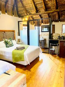 a bedroom with two beds and a desk in it at Impa-Lala Country Estate in Bloemfontein