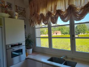 a kitchen with a sink and a window at Villa la provenzale in Camaiore