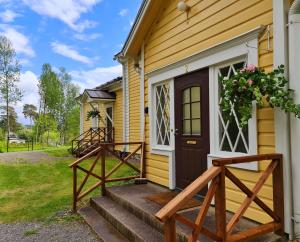 a front door of a yellow house with a brown door at Mansikkaharju Kartano in Leppävirta