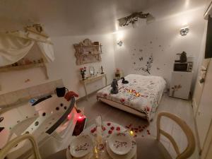 a bedroom with a bed with confetti on the floor at Mon Désir in Grand-Fort-Philippe