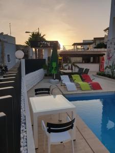 a pool with chairs and a table next to a building at EXEN BY WEEKEND in Bodrum City