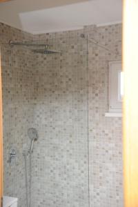 a shower with a glass door in a bathroom at Kuća za odmor Gloria in Travnik +15 photos