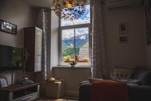 a living room with a window with a view of a mountain at Apartment Dajana in Bovec