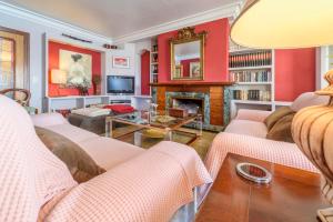 a living room with red walls and a fireplace at Marbat Plus in Port de Soller