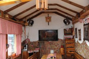 a living room with a television on the wall at Kuća za odmor Gloria in Travnik