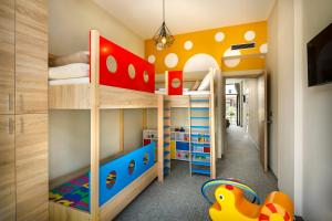 a childs bedroom with two bunk beds and a play area at Hotel Marina - Liburnia in Mošćenička Draga