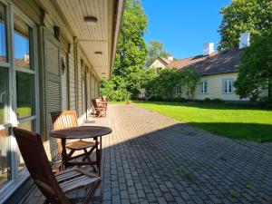 a patio with a table and chairs on a house at Lahe 10 Apartment in Haapsalu +1 photo