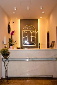 a hair salon with a counter and flowers at Hotel Marily in Pýrgos