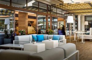 a lobby with couches and tables in a building at Hotel Marina - by Liburnia Hotels & Villas in Mošćenička Draga