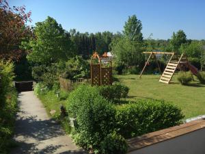 a garden with a swing set and a playground at Unterkunft am Hang in Eutin