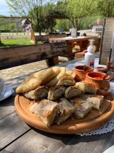 a plate of food on a table with bread at Restoran,,Vuk,, Tršić in TrÅ¡iÄ‡