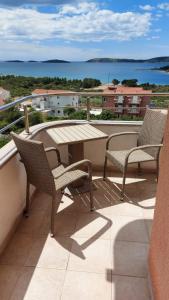 a patio with two chairs and a table on a balcony at Apartment Ruby in Šibenik
