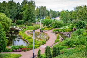 a garden with a bridge and a river at Ilona Apartments -"Home Away From Home" in Kotka