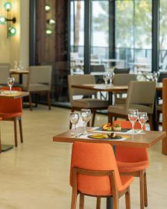 a restaurant with a table and chairs with wine glasses at Sundia Exclusive By Liberty Fethiye Adults Only in Fethiye