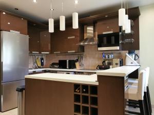 a kitchen with a refrigerator and a counter top at Dózsa 64 in Dunaújváros