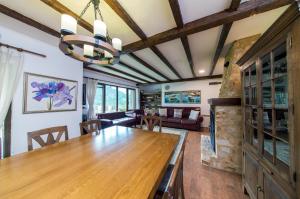 a dining room and living room with a wooden table at Stoykite-Pamporovo Nature Retreat in Stoykite