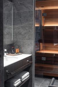 a bathroom with a sink and a mirror at Lapland Hotels Arena in Tampere