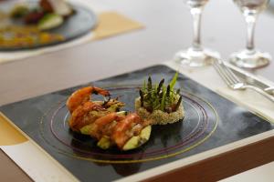 a plate of food with shrimp and rice on a table at Sundia Exclusive By Liberty Fethiye Adults Only in Fethiye