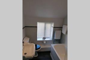 a bathroom with two toilets and a sink and a window at No 1 Church Street in Whitchurch