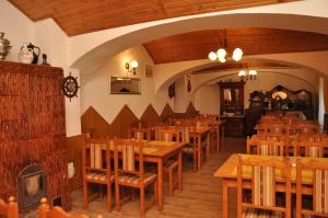 a dining room with wooden tables and chairs at Gloriett Panzió in Fertőboz