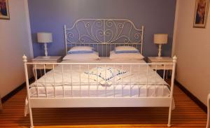 蘇提萬的住宿－Oasis Apartments，配有枕头的白色床和蓝色的墙壁