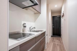a kitchen with a sink and a counter at hotel aima in Tokyo