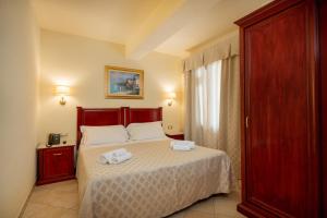Postel nebo postele na pokoji v ubytování Hotel Regina Elena