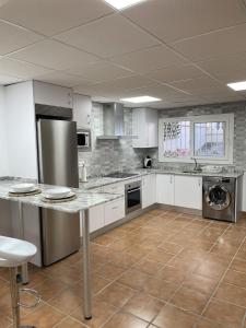 ベナルマデナにあるcasa espigaの広いキッチン(白いキャビネット、ステンレス製の電化製品付)