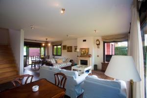 a living room with white furniture and a fireplace at Brisas de Caravia in Prado